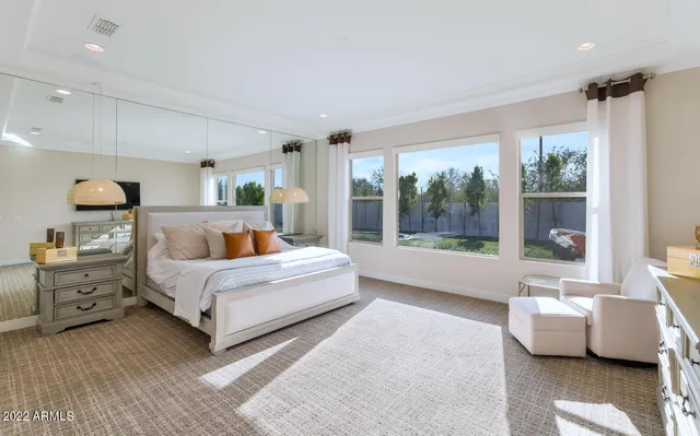 a bedroom with a large bed and a large window