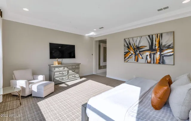 a bedroom with furniture and a flat screen tv