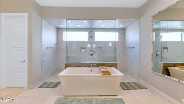 a bathroom with a tub a sink and shower