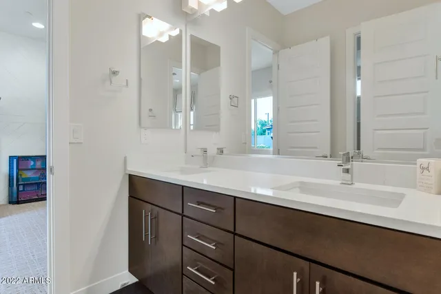 a bathroom with a double vanity sink a mirror and shower