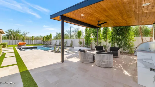 a view of swimming pool with a patio
