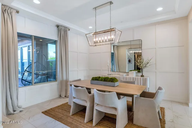 a view of a dining room with furniture wooden floor and chandelier