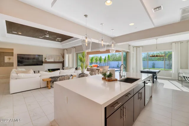 a kitchen with sink refrigerator and large window