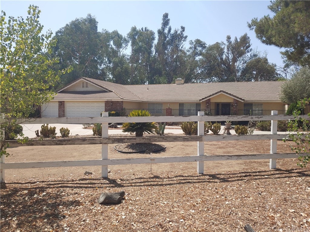 25733 Farmington Road Menifee, CA 92584 - Photo 1 of 1 a front view of a house with garden