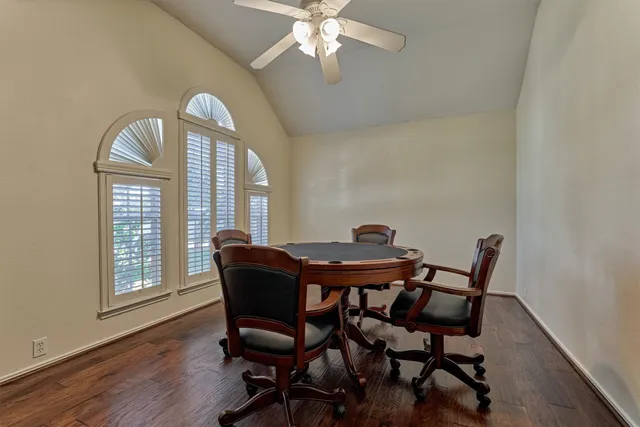 a view of a dining room with furniture a chandelier and wooden floor