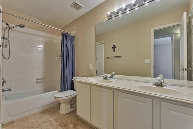 a bathroom with a sink toilet tub and shower