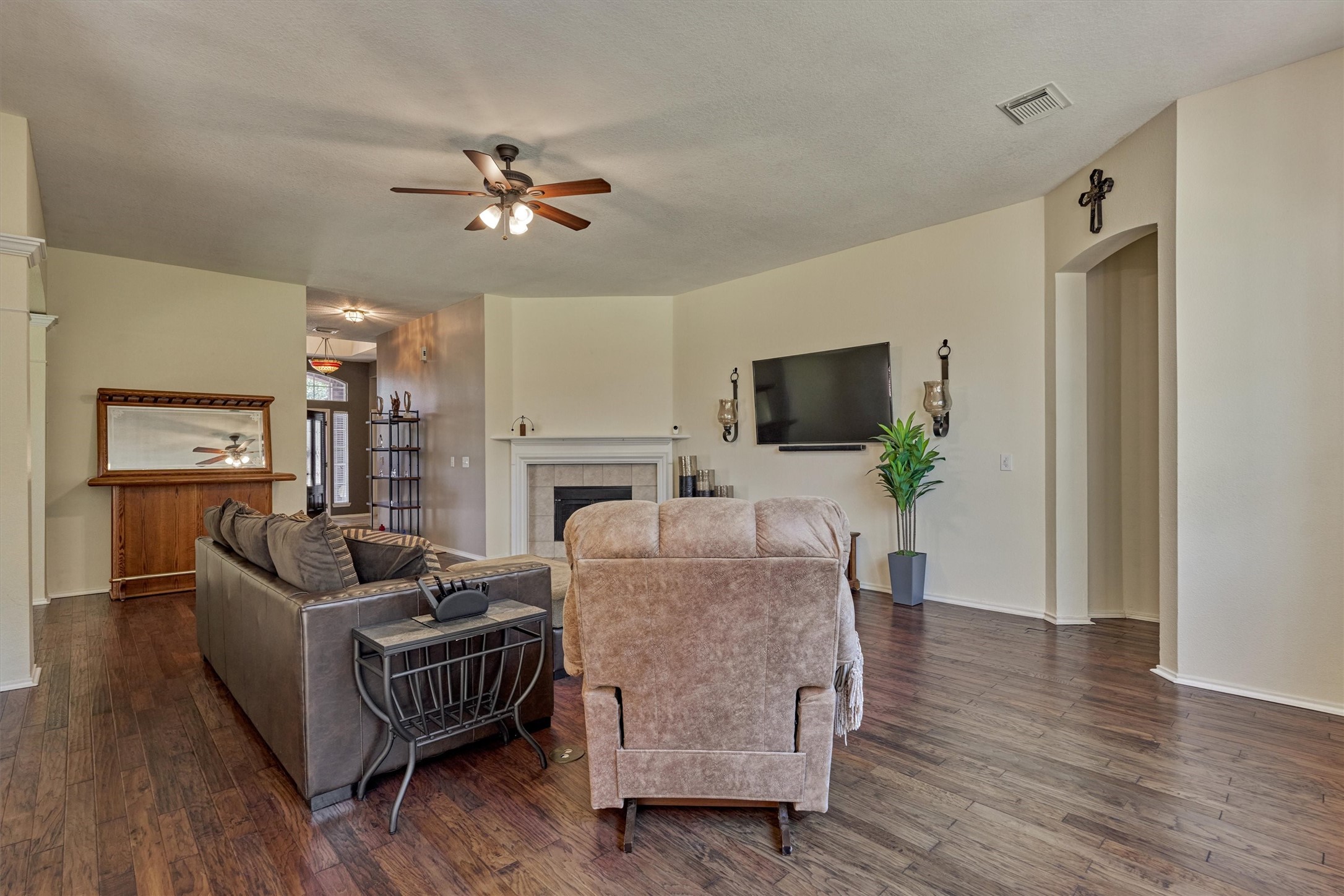 20835 Louetta Oak Drive Spring, TX 77388 - Photo 20 of 37 a living room with furniture a flat screen tv and a fireplace