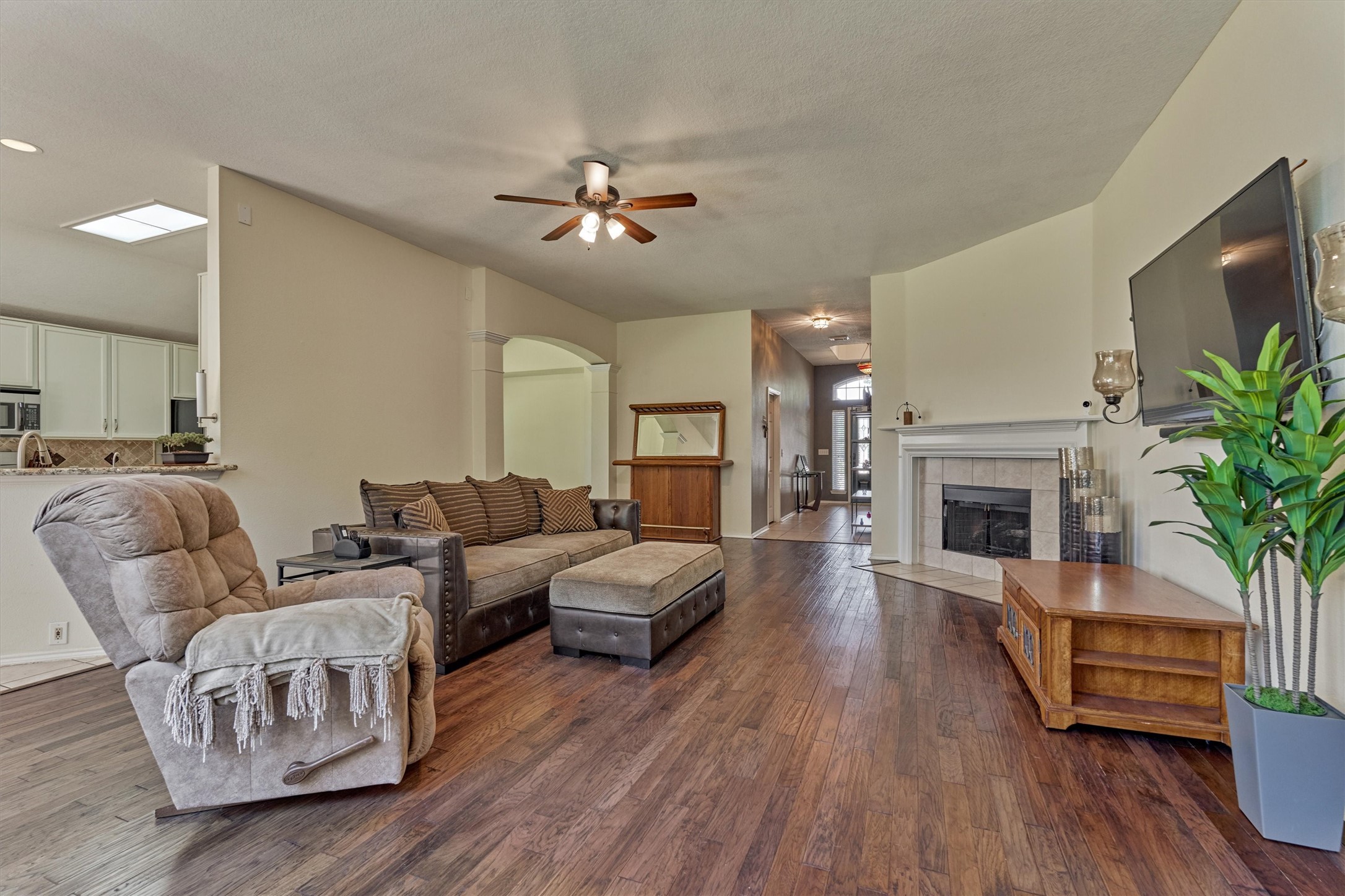 20835 Louetta Oak Drive Spring, TX 77388 - Photo 23 of 39 a living room with furniture a fireplace and a flat screen tv