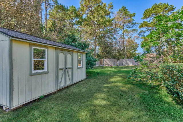a view of backyard with barn and wooden fence
