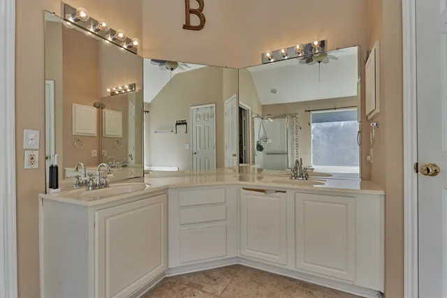 a bathroom with a sink vanity and mirror