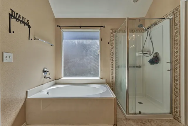 a bathroom with a shower and a sink