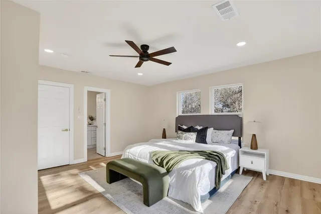 a bedroom with a large bed and a chandelier