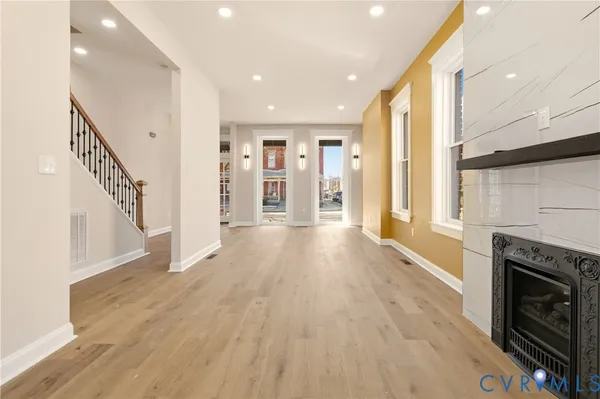 a view of a hallway with wooden floor and closet