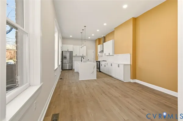 a view of a hallway with wooden floor