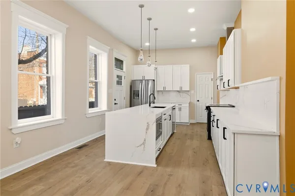 a kitchen with a sink stove and refrigerator