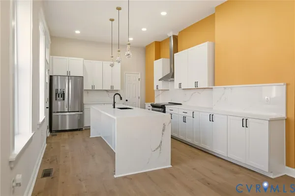 a kitchen with a sink stove and cabinets