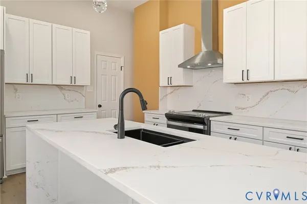 a kitchen with granite countertop cabinets appliances a sink and a window