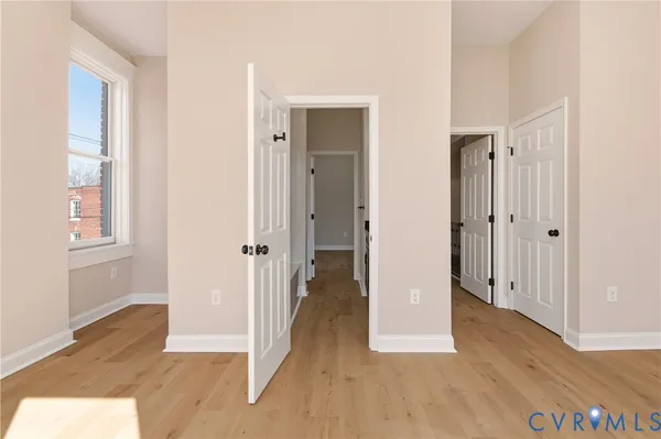 a view of empty room with wooden floor