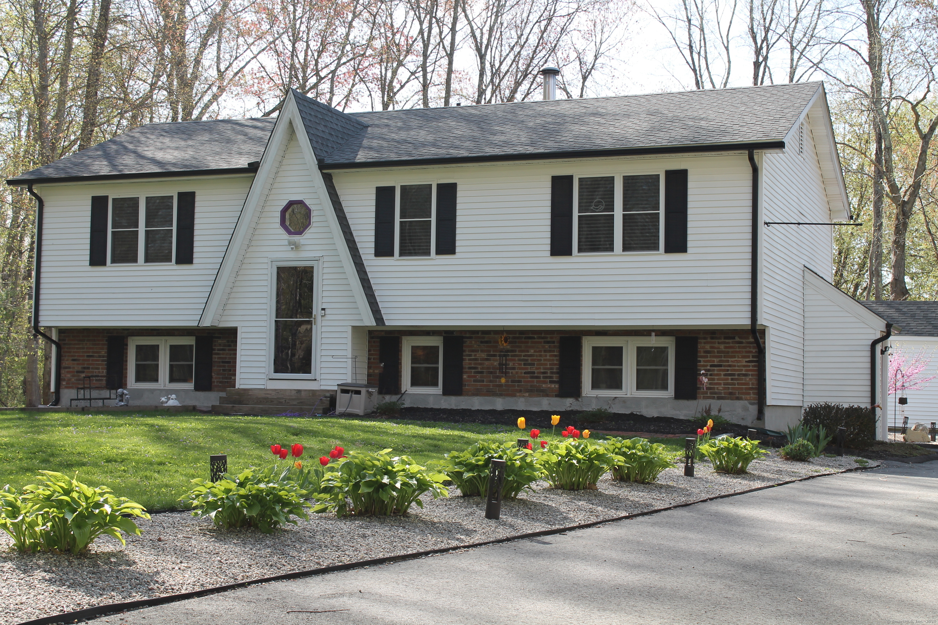 a front view of a house with garden