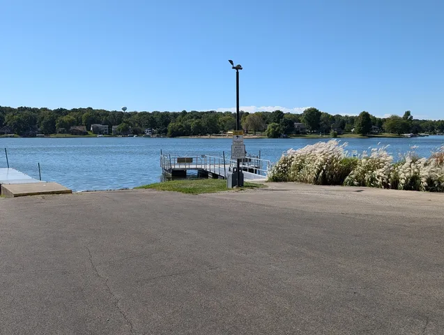 a view of a lake with a house and a big yard