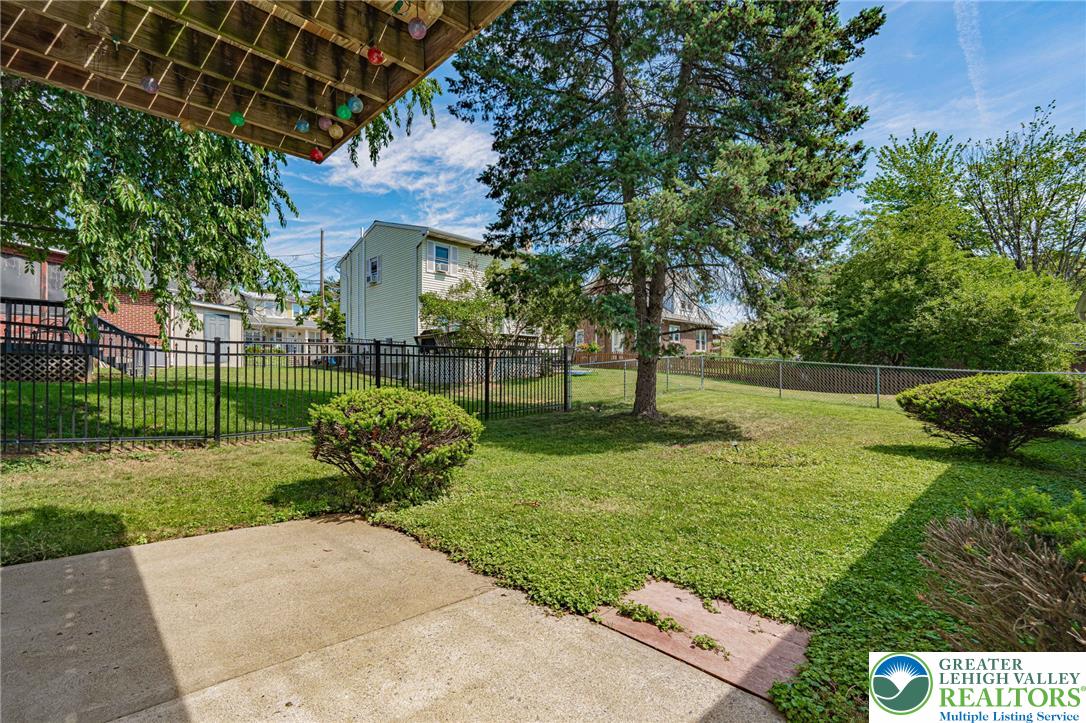 25 North 8th Street Emmaus, PA 18049 - Photo 43 of 51 A well-maintained lawn and sturdy fencing define this inviting outdoor living space.