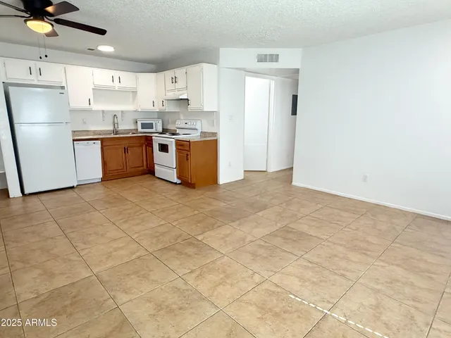 a kitchen with cabinets appliances a sink and a counter top space