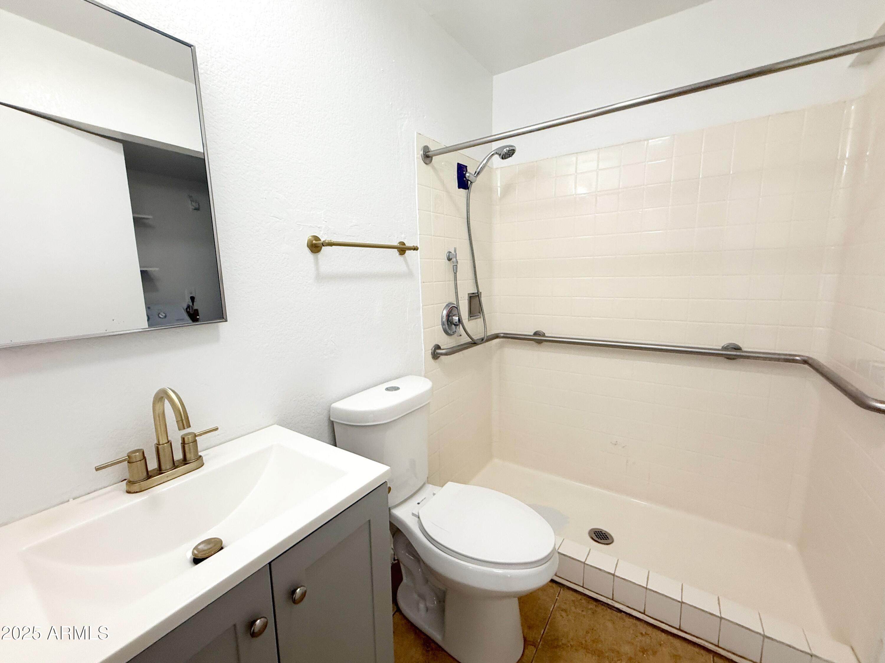 498 East Mesquite Avenue, Unit 4 Apache Junction, AZ 85119 - Photo 8 of 13 a bathroom with a sink toilet and shower