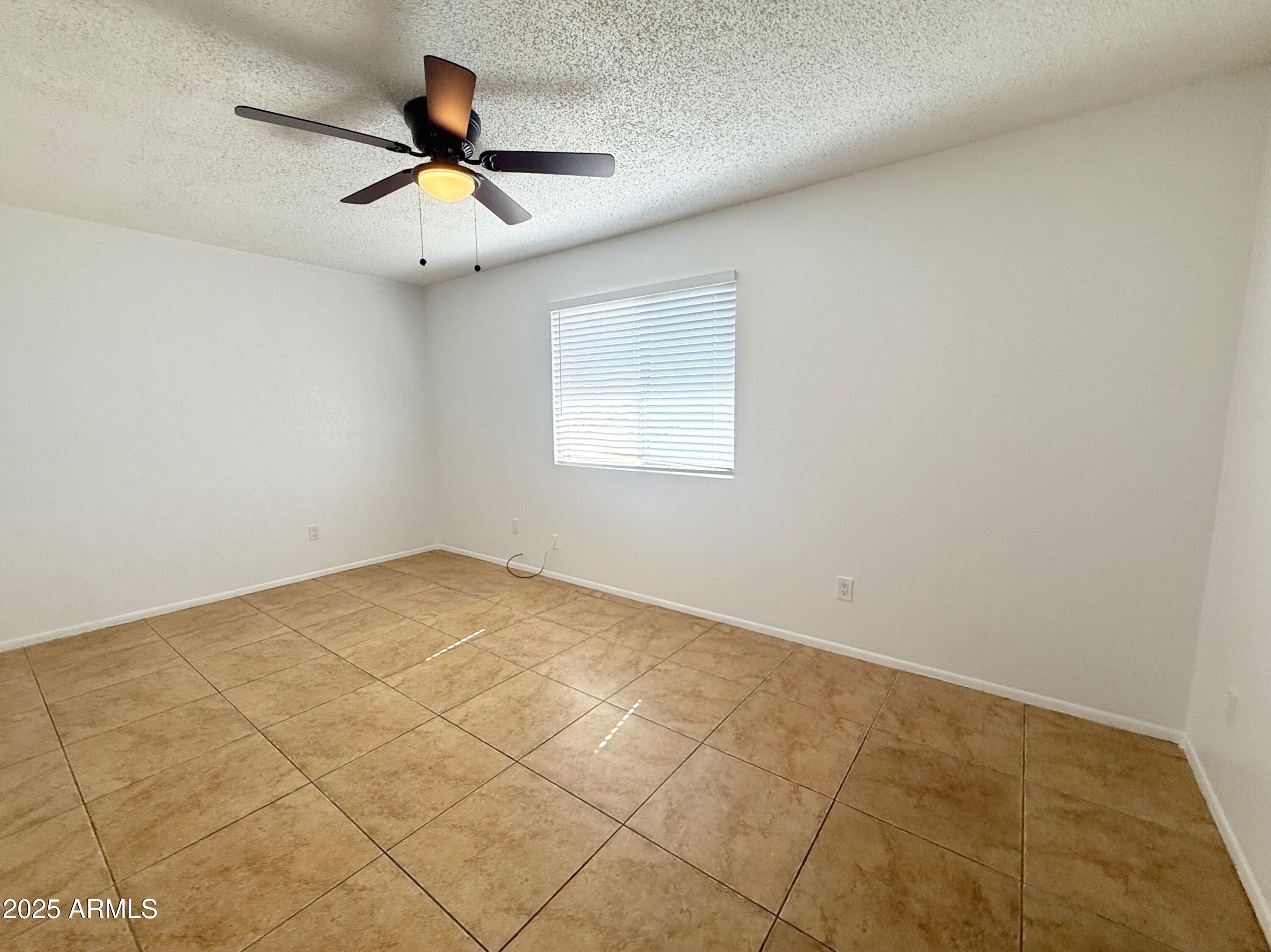 498 East Mesquite Avenue, Unit 4 Apache Junction, AZ 85119 - Photo 9 of 13 a view of empty room with ceiling fan