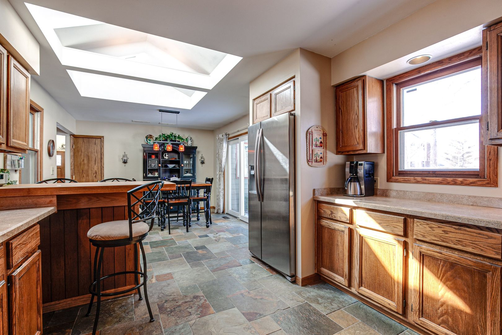 700 West Center Road Palatine, IL 60074 - Photo 11 of 32 a kitchen with stainless steel appliances granite countertop a stove a refrigerator a dining table and chairs with wooden floor