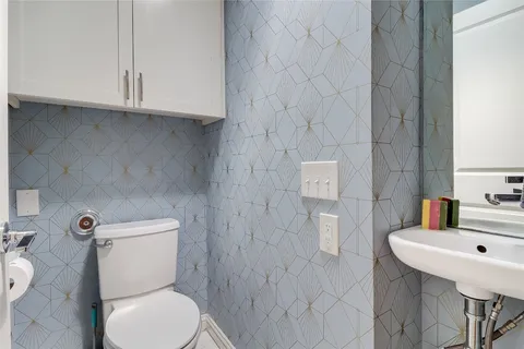 a kitchen with stainless steel appliances granite countertop a dining table chairs refrigerator and sink