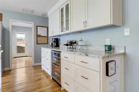 a view of a dining room with furniture a chandelier and wooden floor