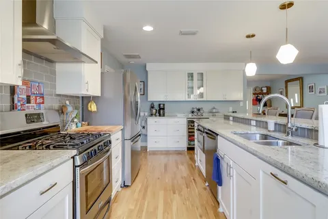 a white toilet sitting next to a bathroom sink