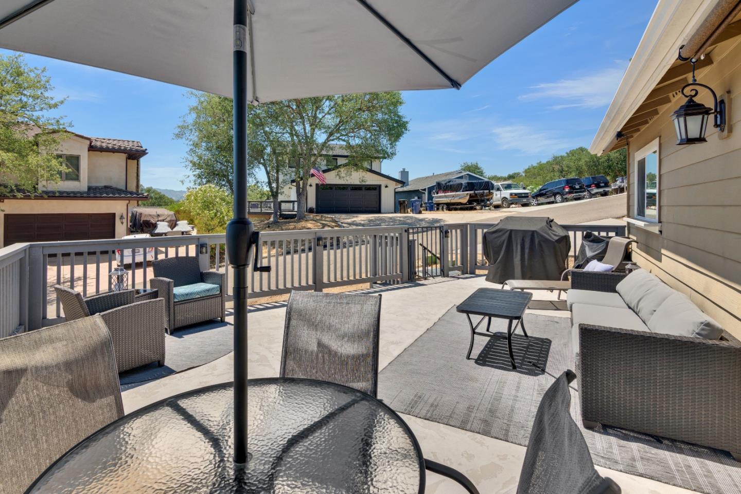 2182 Ridge Rider Road Bradley, CA 93426 - Photo 27 of 37 a view of a patio with couches table and chairs under an umbrella