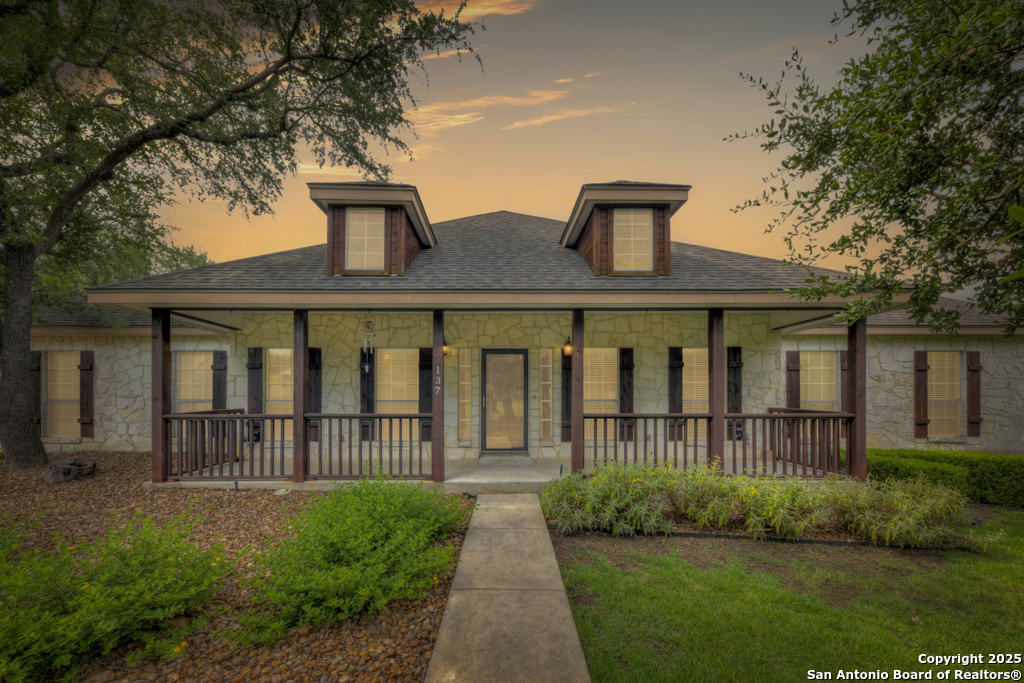 a front view of a house with a garden