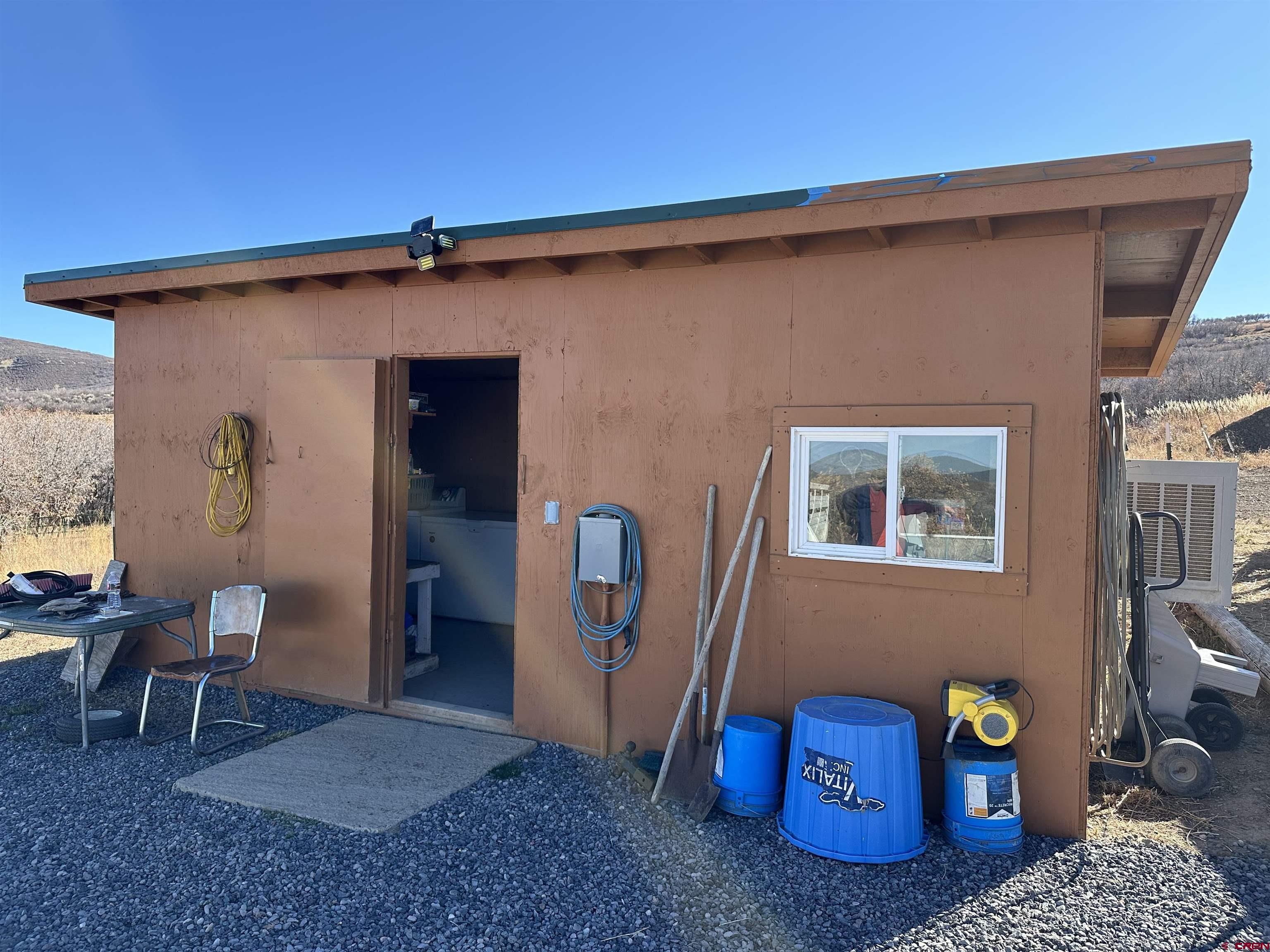 Tbd 8250th Road Crawford, CO 81415 - Photo 6 of 45 a front view of a house with outdoor seating