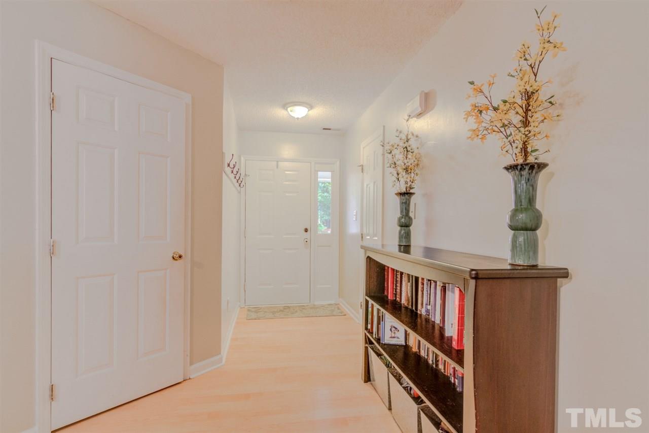 8640 Harps Mill Road Raleigh, NC 27615 - Photo 3 of 23 a view of a hallway with wooden floor and staircase