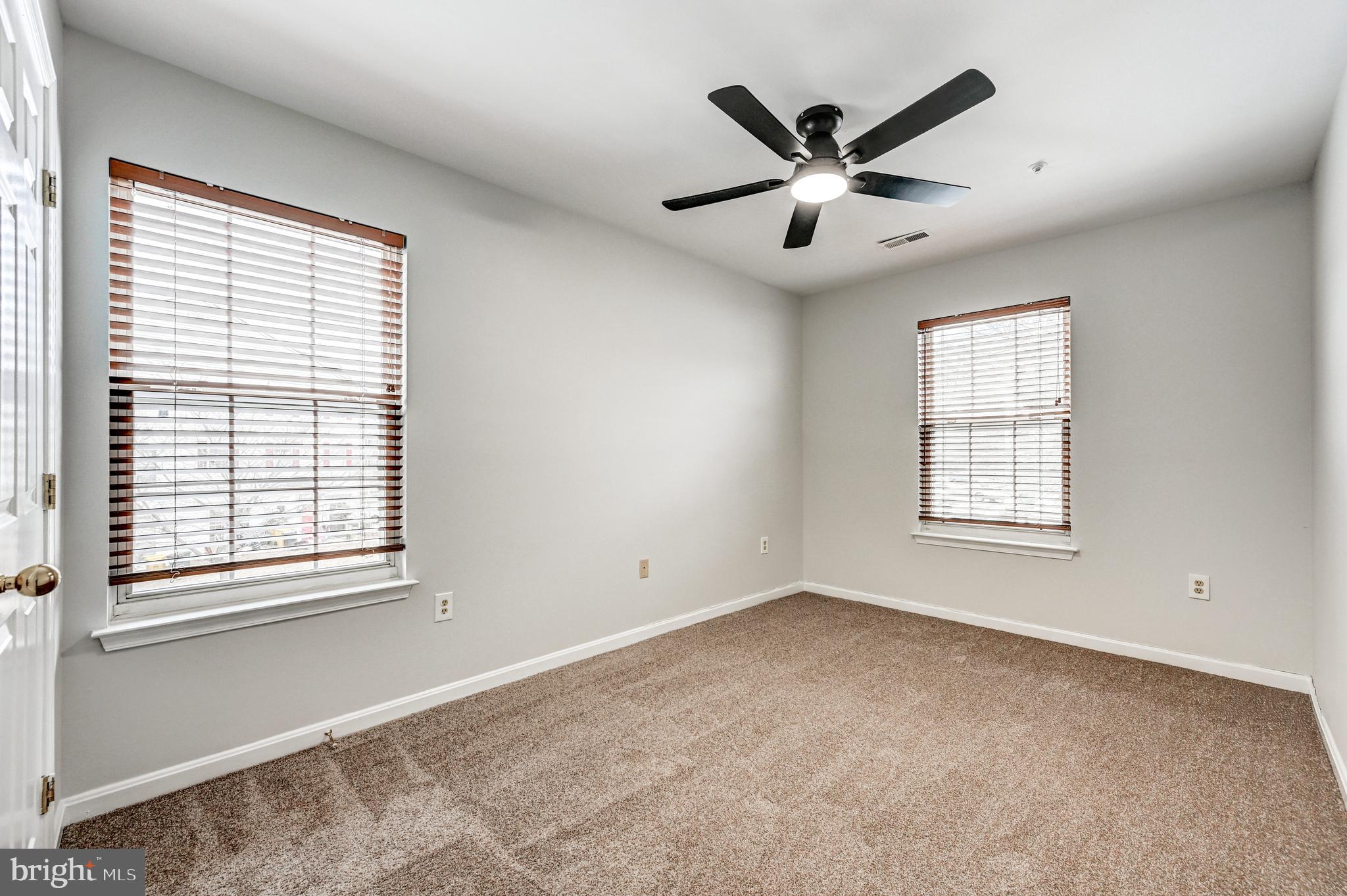 300 Roff Point Drive Odenton, MD 21113 - Photo 19 of 28 a view of an empty room with a ceiling fan and a window