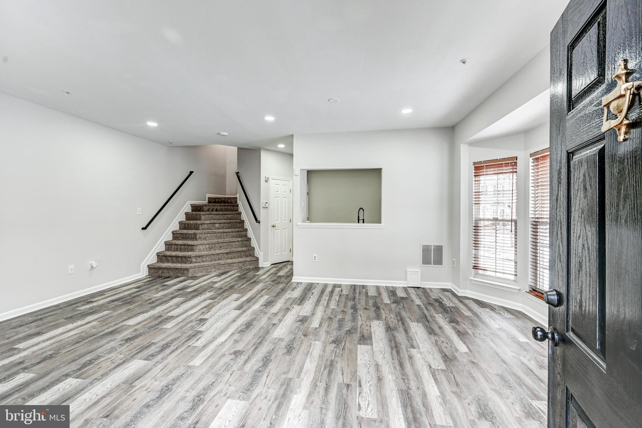 300 Roff Point Drive Odenton, MD 21113 - Photo 3 of 28 wooden floor in an empty room with a fireplace