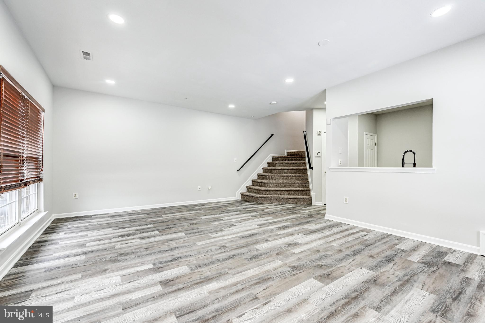 300 Roff Point Drive Odenton, MD 21113 - Photo 5 of 28 an empty room with wooden floor and stairs