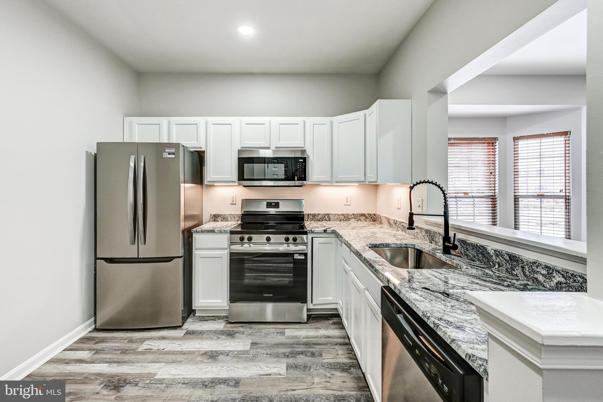 300 Roff Point Drive Odenton, MD 21113 - Photo 8 of 28 a kitchen with stainless steel appliances granite countertop a refrigerator sink stove microwave and cabinets