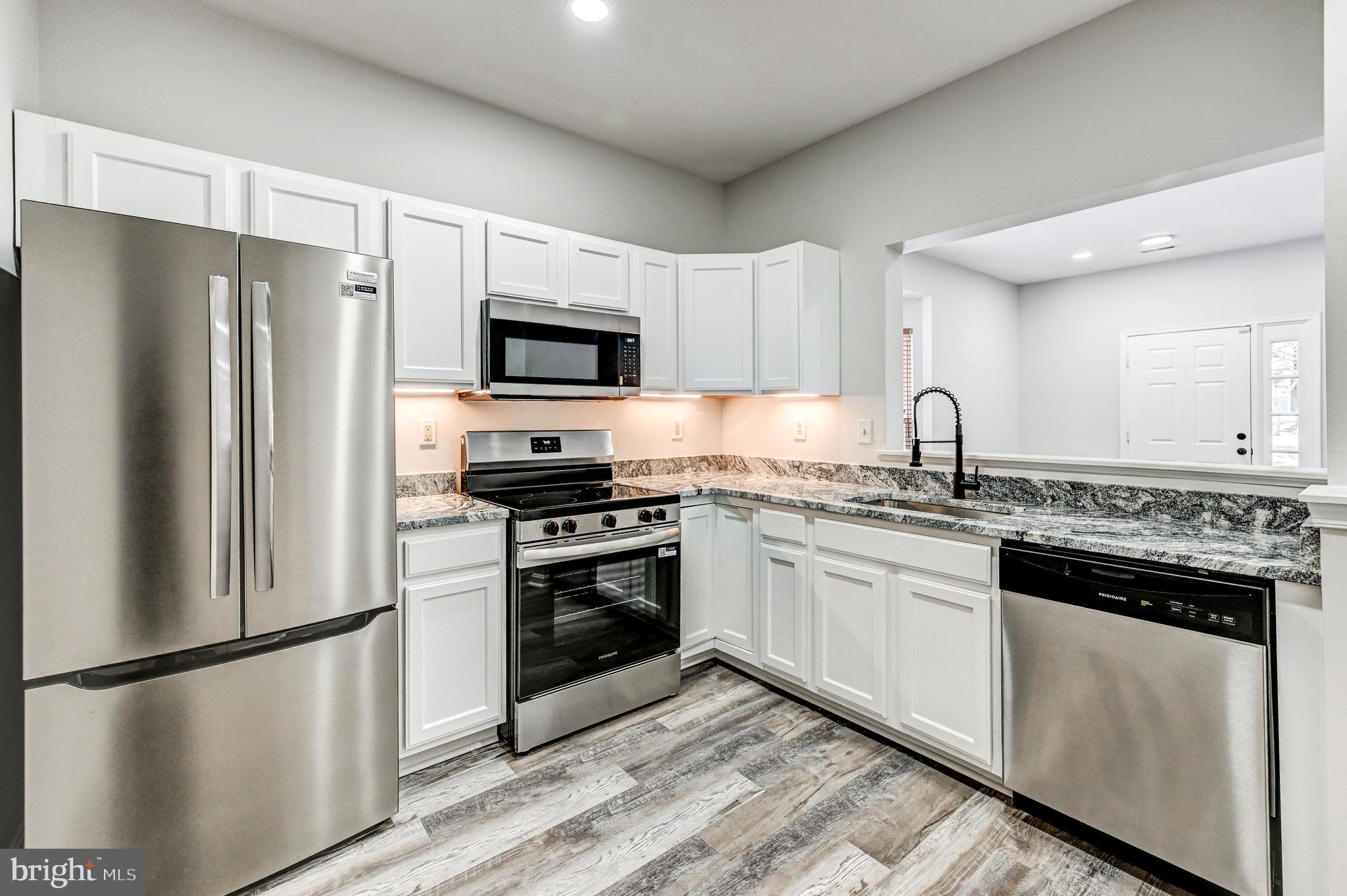 300 Roff Point Drive Odenton, MD 21113 - Photo 9 of 28 a kitchen with stainless steel appliances a refrigerator sink and microwave