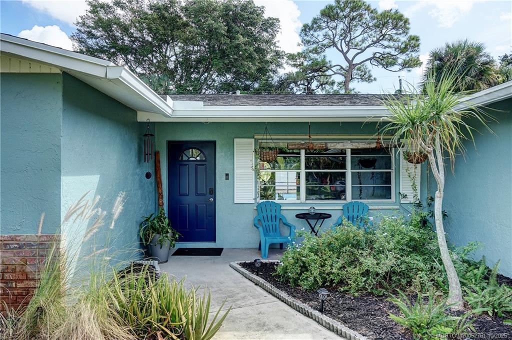 905 Southeast Flamingo Avenue Stuart, FL 34996 - Photo 1 of 36 a front view of a house with garden