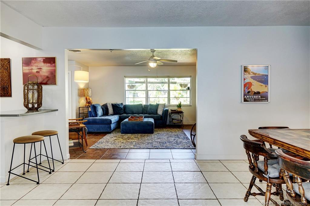 905 Southeast Flamingo Avenue Stuart, FL 34996 - Photo 11 of 36 a living room with furniture and a window