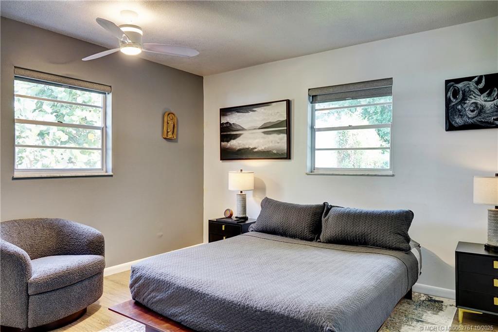 905 Southeast Flamingo Avenue Stuart, FL 34996 - Photo 21 of 36 a bedroom with a bed and a couch