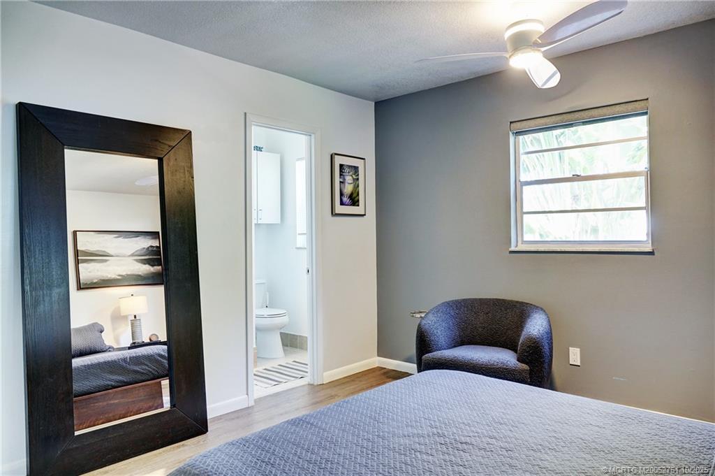 905 Southeast Flamingo Avenue Stuart, FL 34996 - Photo 22 of 36 a bedroom with a bed and a window