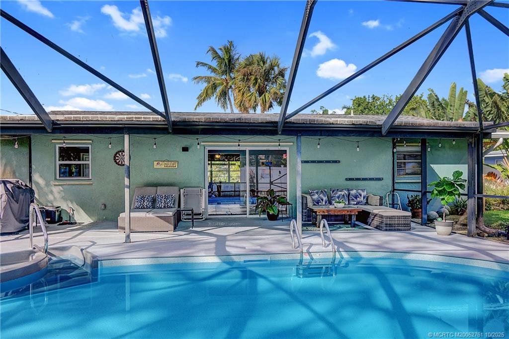 905 Southeast Flamingo Avenue Stuart, FL 34996 - Photo 26 of 36 a view of the patio with table and chairs potted plants and wooden fence
