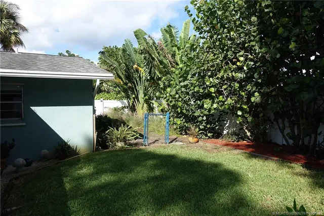 a backyard of a house with plants and trees