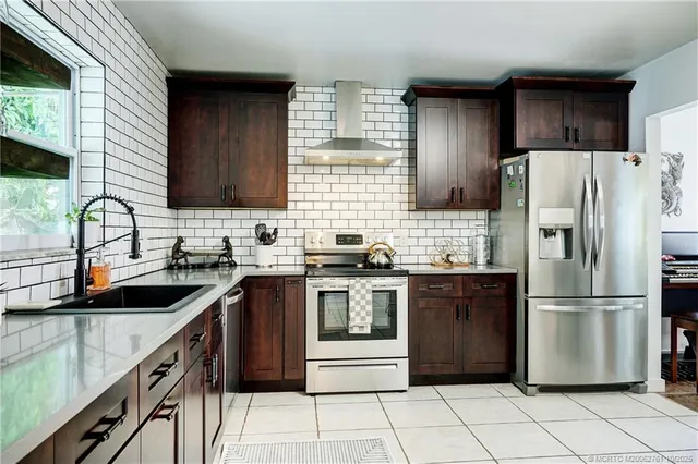 a kitchen with a sink stove and refrigerator