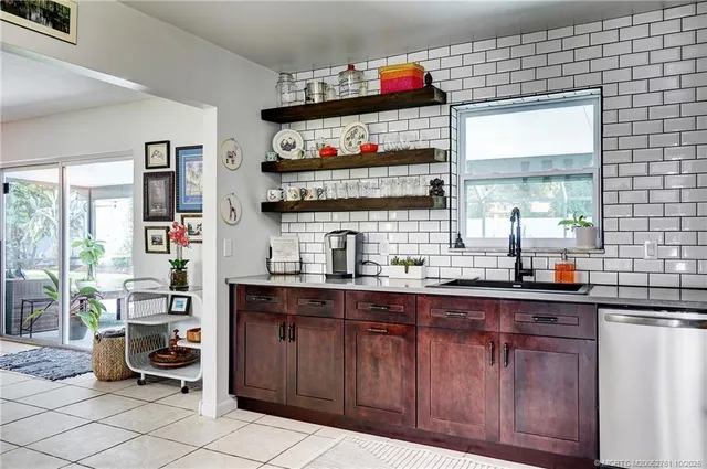 a kitchen with granite countertop a sink and cabinets