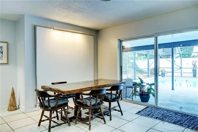 a view of a dining room with furniture and a window